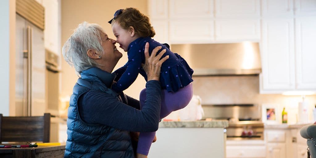 a grandmother holds her grandchild