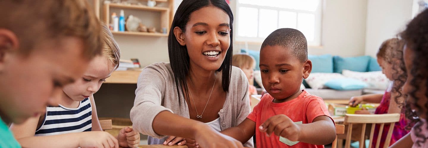 a daycare teacher helps her students