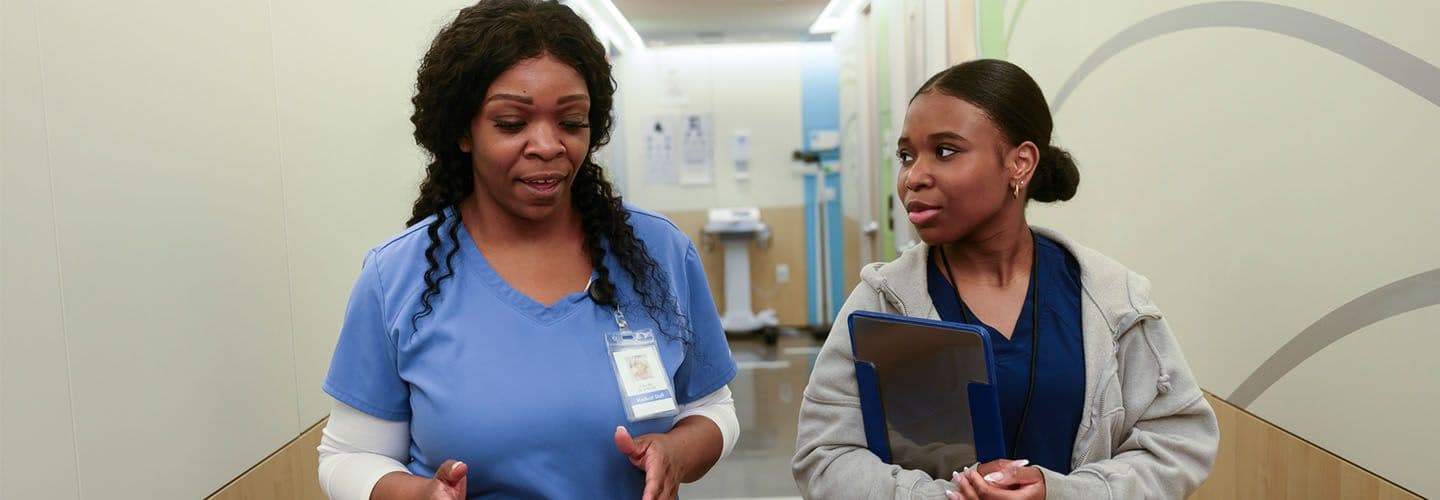 a medical professional talks to a young coworker