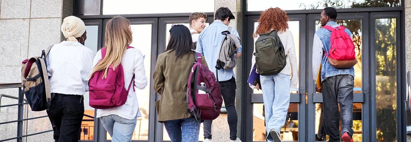 a group of students walk into a building together