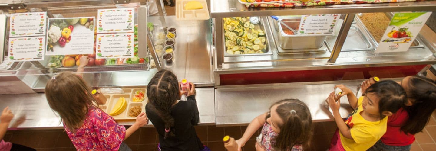 school children stand in the lunch line