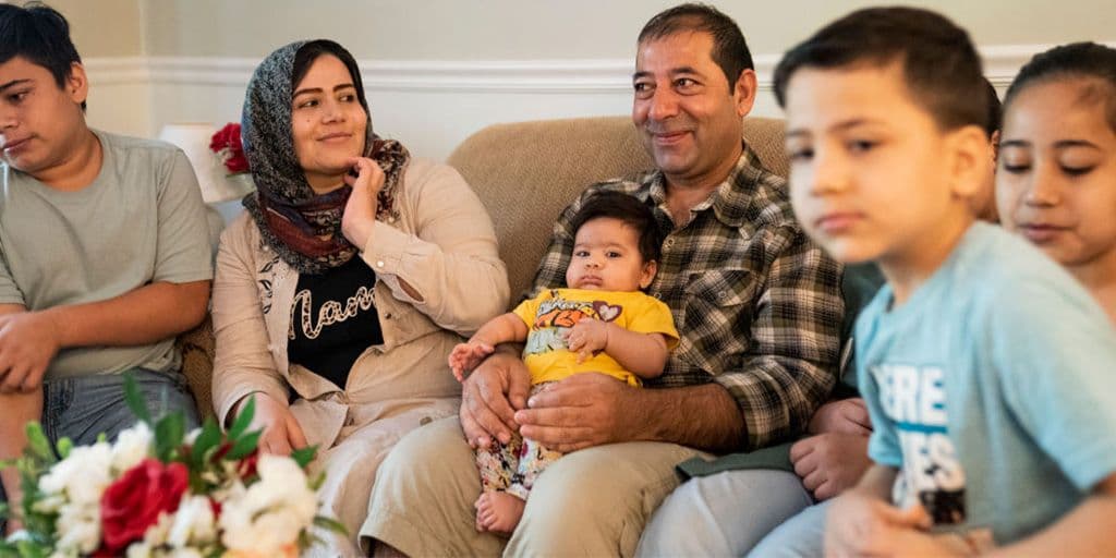a family sitting together on the couch