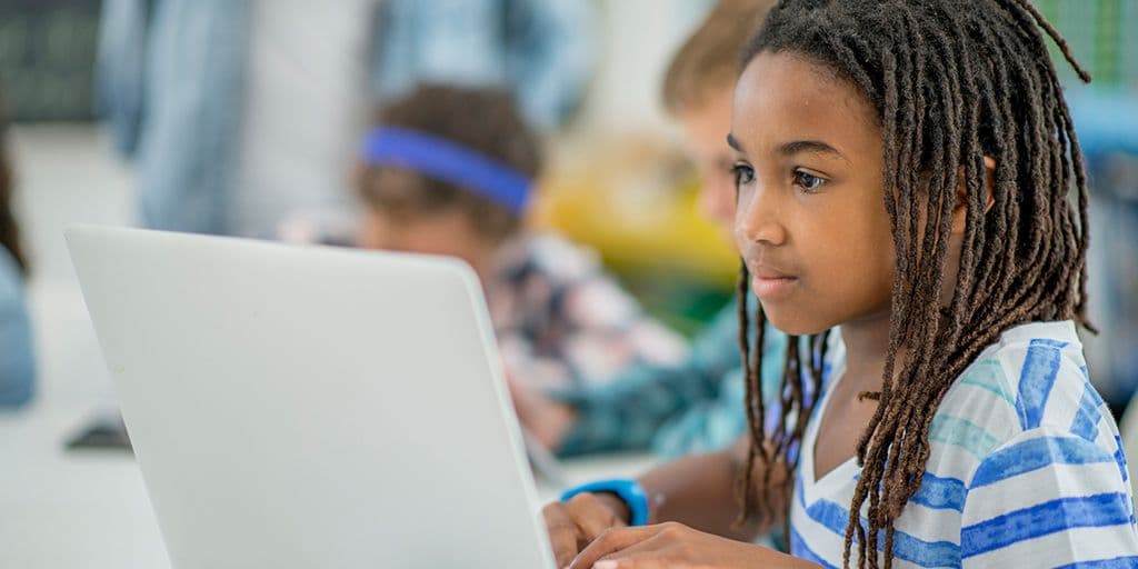 A young child works at a computer