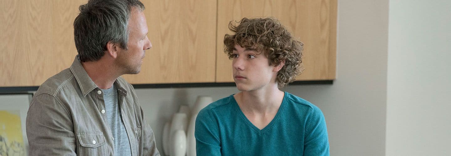 a father and son have a serious conversation