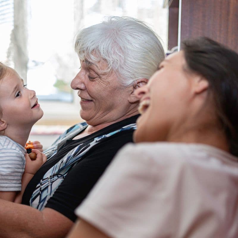 Multigenerational family get together at home. Sharing family moments and caring for each other.