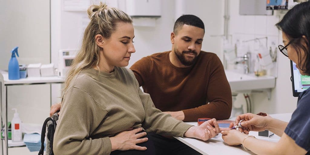 a pregnant couple at the doctor's office