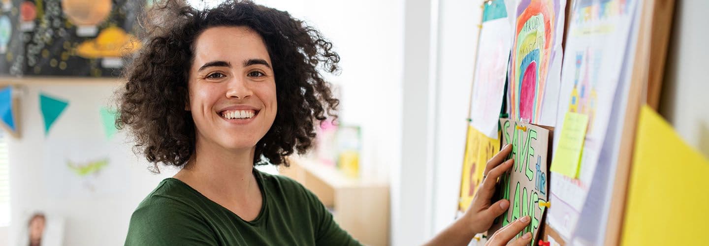a teacher smiles in their classroom