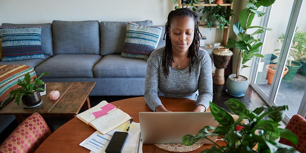 Shot of a young woman using a laptop while working from home