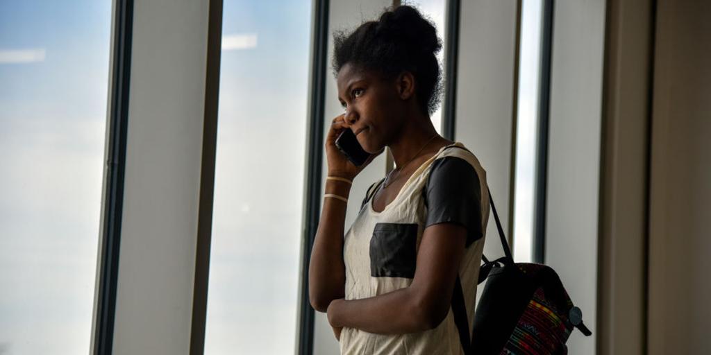 a young woman talks on the phone