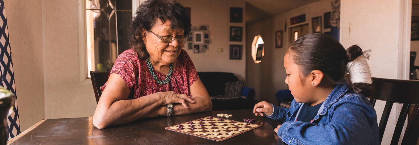 a grandmother plays a game with her grandchild