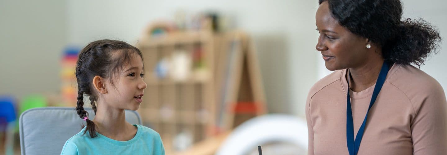 a young girl talks to a counselor
