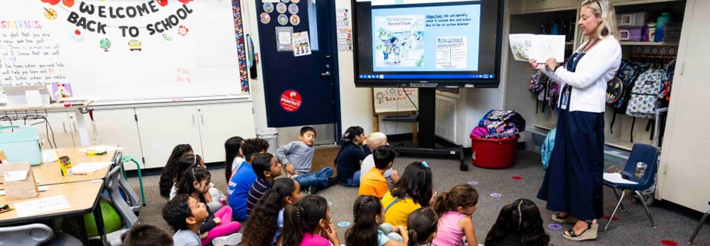 a teacher reads to a classroom of students