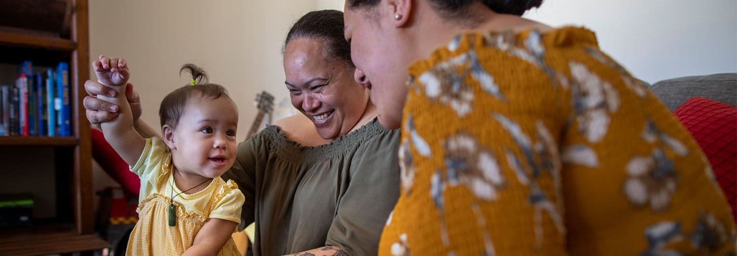 a mother and grandmother play with a young child
