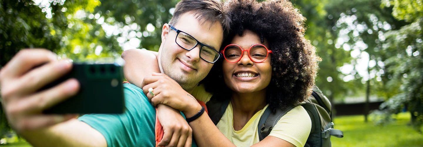 a young couple smiles in nature