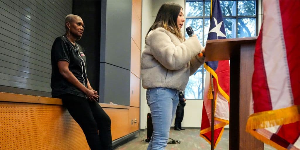 a student speaks at a town hall meeting