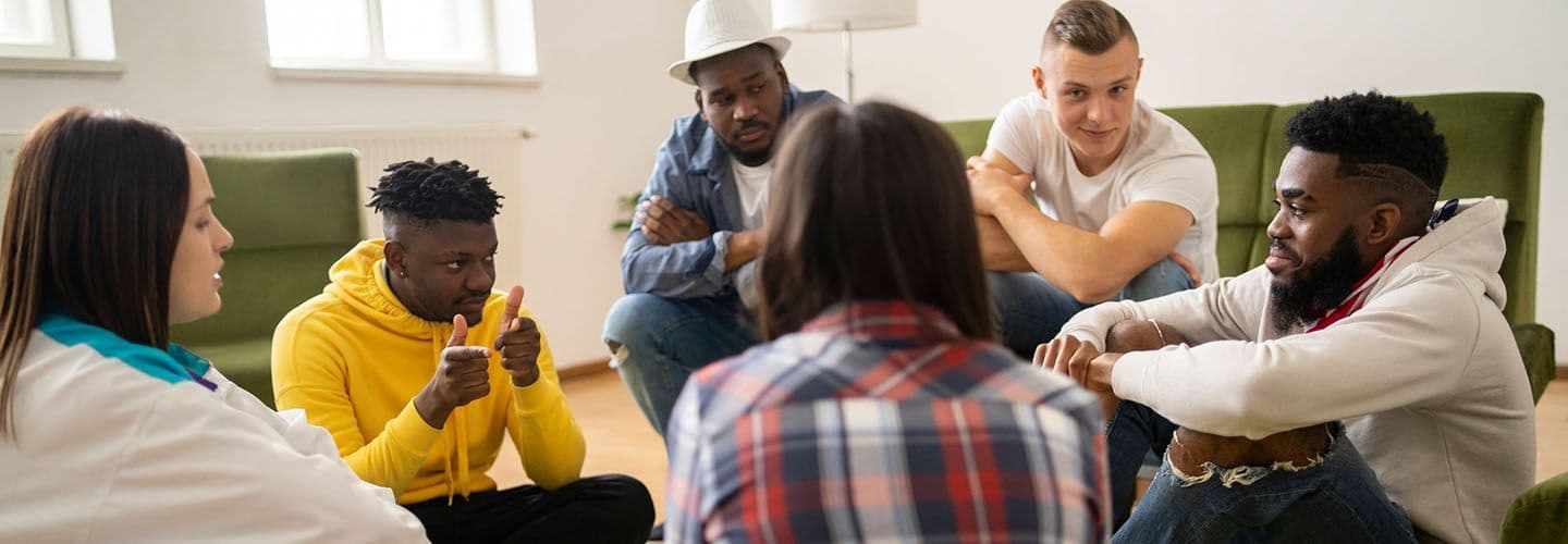 a group of friends sit and talk together