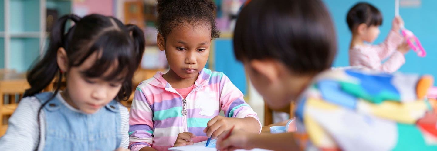 young children play at a table in daycare